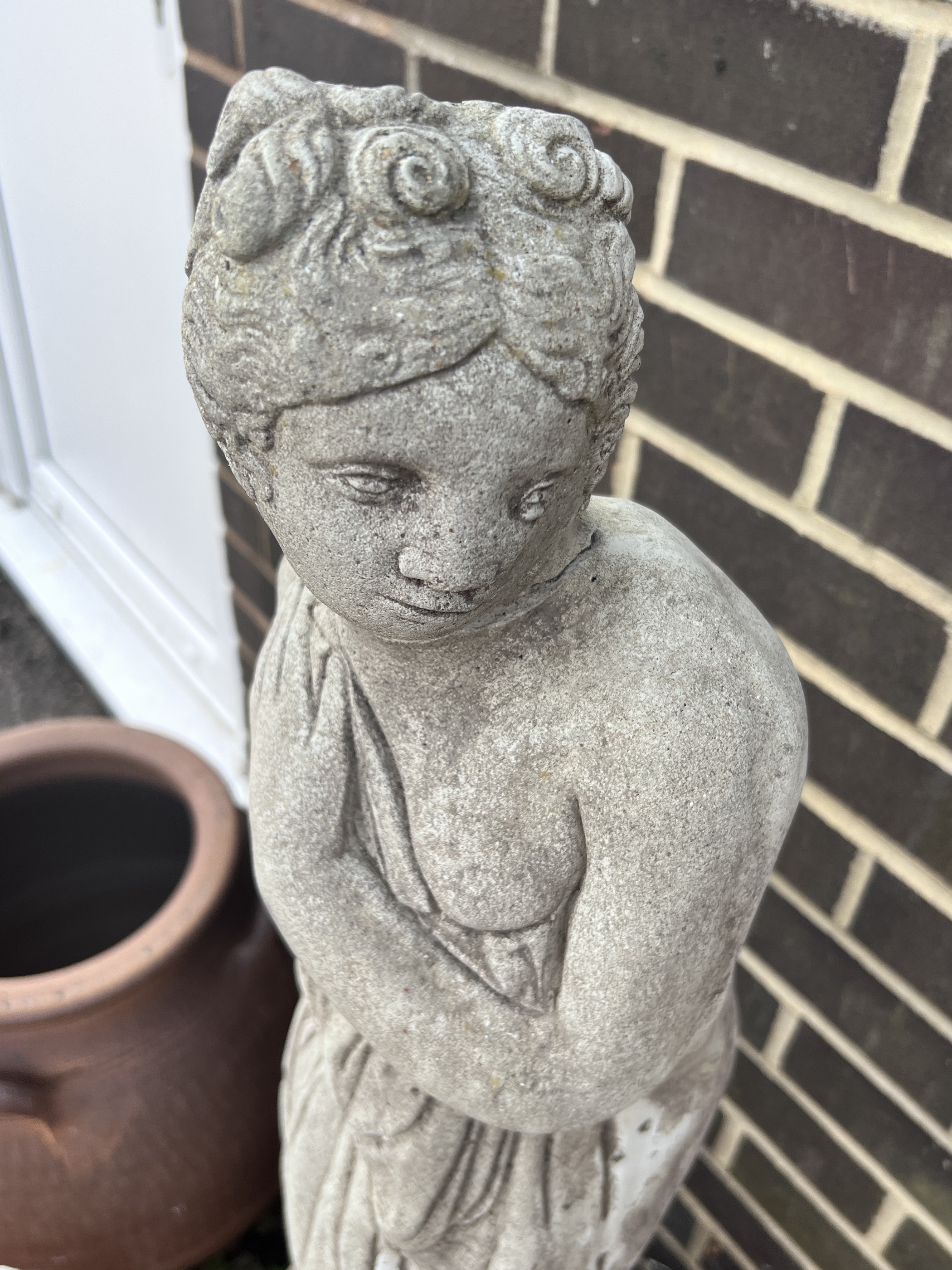 A reconstituted stone garden ornament of a robed lady, head detached, and a stone birdbath, tallest 120cm